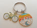 Outdoor Mountain Biking Keychain; Mountain, Trees, River & Orange Sunset Sky Scene Disc Charm Keychain with Bike Charm