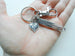 A charm keychain as a gift for a student studying to be a Occupational Therapist. The keychain has a OT heart charm, an enjoy the journey charm, and a swivel clasp. The enjoy the journey charm is about 1.75 inches long.